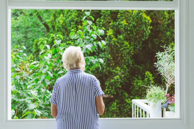 Woman looking at view from window
