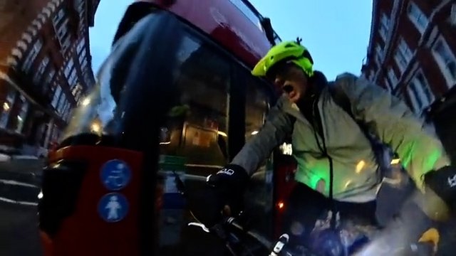 A screengrab of a video showing Jeremy Vine shouting as a bus close passes him in London.