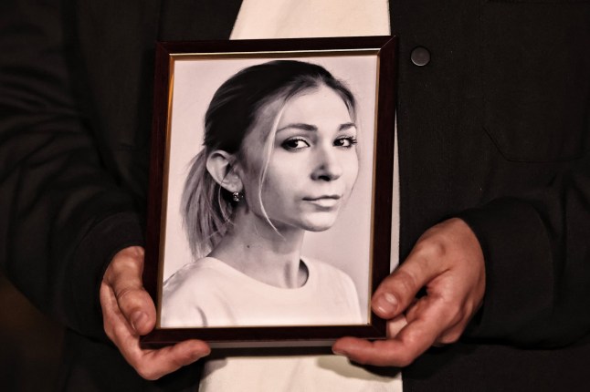 KYIV, UKRAINE - OCTOBER 11: People hold portraits of Ukrainian journalist Victoria Roshchyna during a commemoration for Roshchyna who died in Russian captivity, on Maidan Nezalezhnosti (Independence Square) on October 11, 2024 in Kyiv, Ukraine. Victoria Roshchyna disappeared on August 3, 2023 in the temporarily occupied territories while performing work duties. It became known about the death of the journalist in Russian captivity on October 10. She was on the lists for POW exchange and was supposed to return to Ukraine but died during the staging from Taganrog to Moscow. (Photo by Yan Dobronosov/Global Images Ukraine via Getty Images)