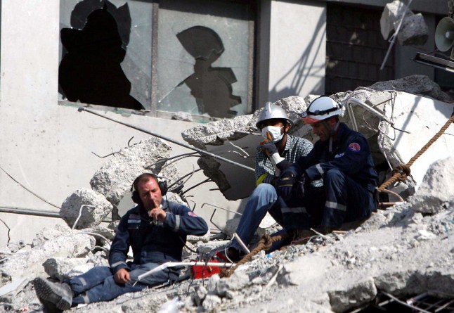 Mandatory Credit: Photo by Sipa/REX/Shutterstock (554433a) Rescuers ask for quiet during the search for survivors on the ruins of a department building after the powerful quake RESCUE EFFORTS AT EARTHQUAKE SITES, ISLAMABAD, PAKISTAN - 10 OCT 2005