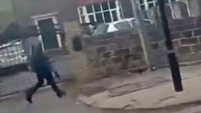 A video screengrab appearing to show a masked figure carrying a crossbow.