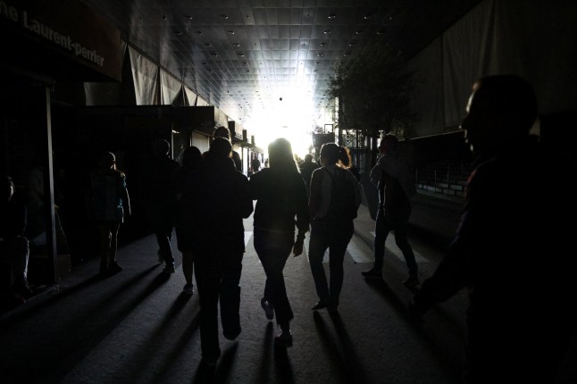 People walk in a building during a power outage, in Madrid, Spain, April 28, 2025. REUTERS/Violeta Santos Moura