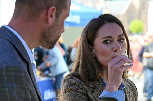 TOBERMORY, SCOTLAND - APRIL 29: Prince William, Prince of Wales and Catherine, Princess of Wales react as talk and sample produce at a Whey-based spirit stall holder's stall as they tour an artisan market on April 29, 2025 in Tobermory, Scotland. The Prince and Princess of Wales are on a two-day visit to the Isles of Mull and Iona on the 29th and 30th of April to engage with rural island communities. During their time on the islands, they will connect with local residents, highlighting the value of social bonds and underscoring the importance of safeguarding and advocating for the natural environment. (Photo by Oli Scarff - WPA Pool/Getty Images)