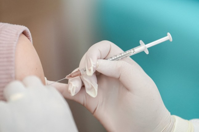 FILE PHOTO: A woman receives a booster dose of Pfizer-BioNTech vaccine against the coronavirus disease (COVID-19) in Bangkok, Thailand, January 5, 2023. REUTERS/Athit Perawongmetha/File Photo
