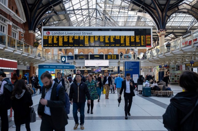 The interior of Liverpool Street station with people.
