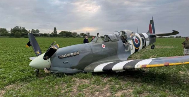 A world war two Spitfire plane on a field in Kent.