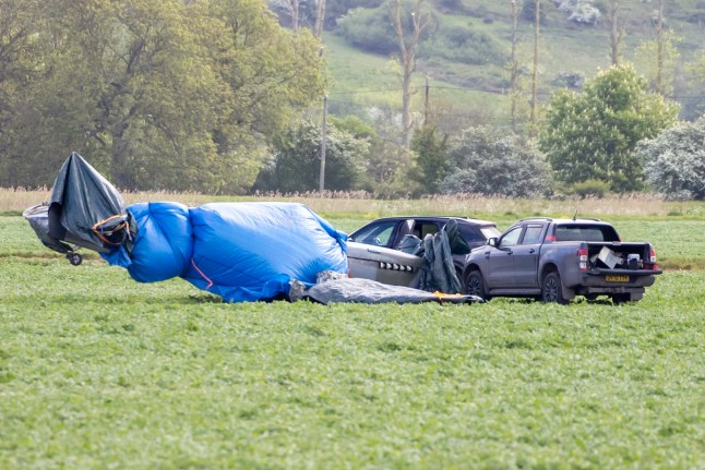 Volunteers have been spotted protecting a historic 1940s-era Spitfire that crash landed in a crop field near Hythe, Kent, on Saturday afternoon. The pilot and passenger were unharmed, and the aircraft is being safeguarded until it can be properly recovered. Pictured: gv,general view Ref: BLU_S8306703 040525 NON-EXCLUSIVE Picture by: / SplashNews.com Splash News and Pictures USA: 310-525-5808 UK: 020 8126 1009 eamteam@shutterstock.com World Rights