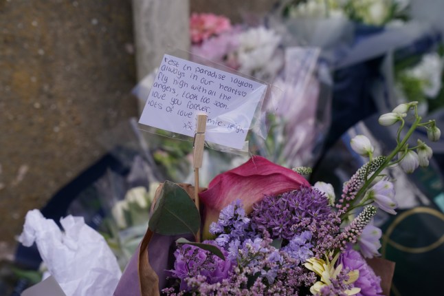 Floral tributes left by the gates of Fairfield Industrial Park in the Bill Quay area of Gateshead where a body believed to be that of 14-year-old Layton Carr was located deceased inside a building following a fire.