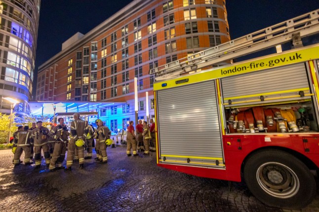 ?? Licensed to London News Pictures. 06/05/2025. London, UK. London Fire Brigade was called to the block of flats near Canary Wharf in east London after receiving 26 calls alerting them at around 8.47pm. Eight fire engines and around 60 firefighters arrived at the scene on Fairmont Avenue. A three-bedroom flat on on the 13th floor of the 20-storey building had set alight. Photo credit: Marcin Nowak/LNP