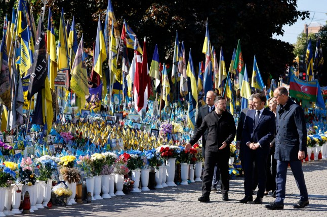 (From L) Poland's Prime Minister Donald Tusk, Ukraine's President Volodymyr Zelensky, Britain's Prime Minister Keir Starmer, France's President Emmanuel Macron, Olena Zelenska and Germany's Chancellor Friedrich Merz pay their respects to the victims of war at the Memorial for the Fallen at the Independence Square (Maidan) in Kyiv on May 10, 2025, ahead of a gathering of European leaders in the Ukranian capital. The leaders of Britain, France, Germany and Poland make an unprecedented joint visit to Kyiv on May 10, 2025 for talks with Ukraine's President Volodymyr and to urge Russia to agree a ceasefire, a joint statement said. (Photo by Ludovic MARIN / POOL / AFP) (Photo by LUDOVIC MARIN/POOL/AFP via Getty Images)