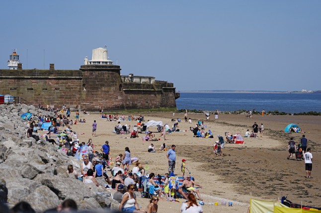 People enjoy the warm weather on New Brighton beach on the Wirral, Merseyside. Above-average temperature are forecast for the UK this weekend before thunderstorms hit parts of the country on Sunday, the Met Office has said. Picture date: Saturday May 10, 2025. PA Photo. Photo credit should read: Peter Byrne/PA Wire