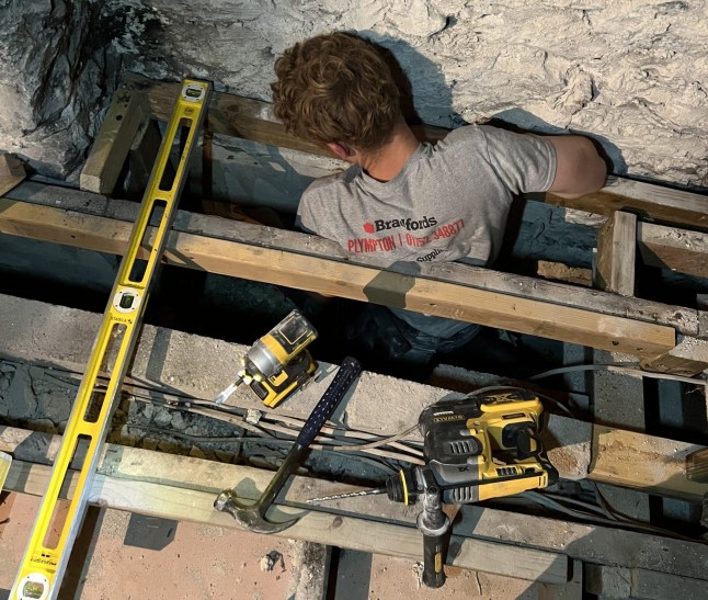 Man carrying out building work on house.