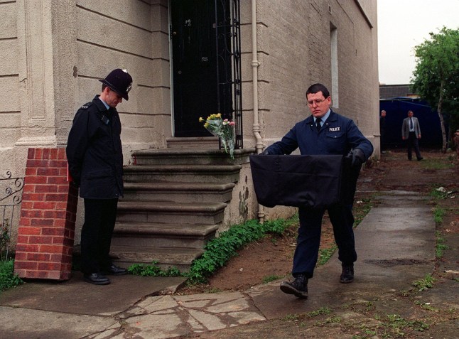 G4RW5G A policeman carries the remains of a young woman from the former home of Frederick West. 25 Midland Road, Gloucester. Fred West has been charged with the murders of 10 women.