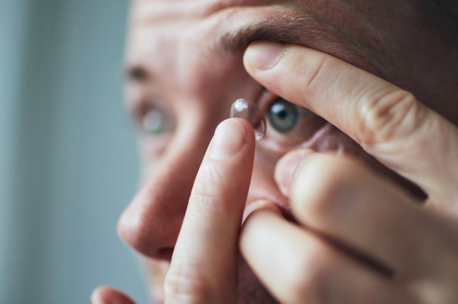 Close-Up Of Woman Applying Lens