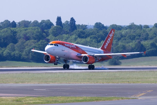 A passenger aircraft, operated by EasyJet Plc, touches down at London Luton Airport in Luton, UK, on Tuesday, May 13, 2025. EasyJet are due to report their half-year results on Thursday, May 22. Photographer: Chris Ratcliffe/Bloomberg via Getty Images