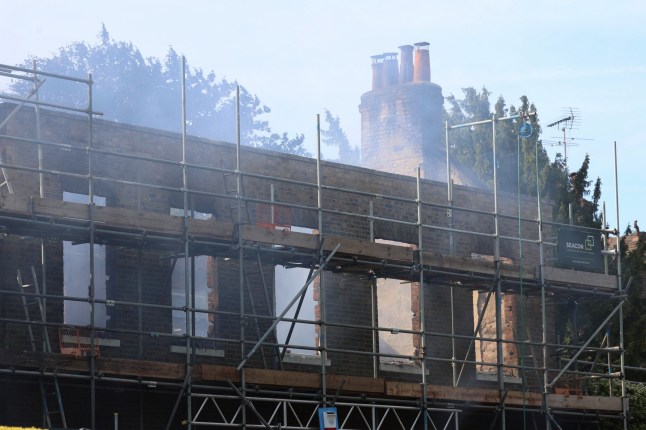Hollybush House in Barnet with smoke rising from the remains of the house.