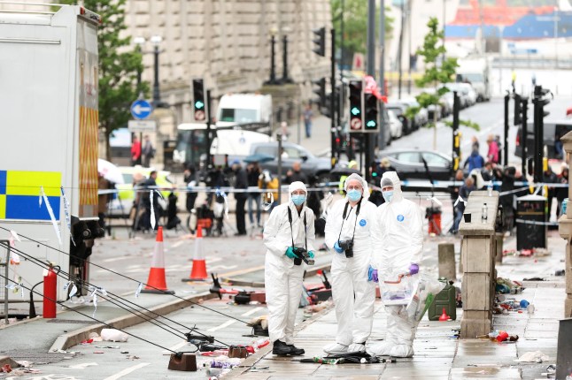 LIVERPOOL, ENGLAND - MAY 27: Crime Scene Investigators at the scene of the Liverpool FC parade incident on Water Street on May 27, 2025 in Liverpool, England. Investigation and cleanup continued this morning after a car ploughed into a crowd gathered yesterday for the Liverpool F.C. victory parade, injuring nearly 50 people, including four children. Authorities said the suspect was arrested and they are not treating it as an act of terrorism. (Photo by Jan Kruger/Getty Images)
