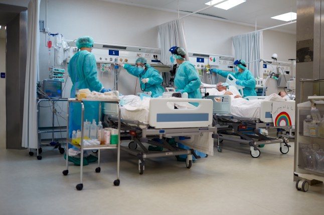 Hospital COVID Healthcare workers adjusting the oxygen supply to a COVID patient. (Credits: Getty Images)