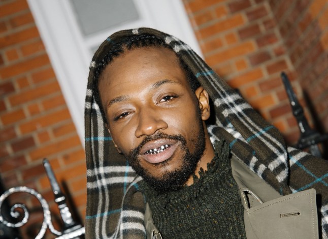 Sosa Henkoma - he has a gold grill in his mouth and is wearing a coat with a Burberry hood