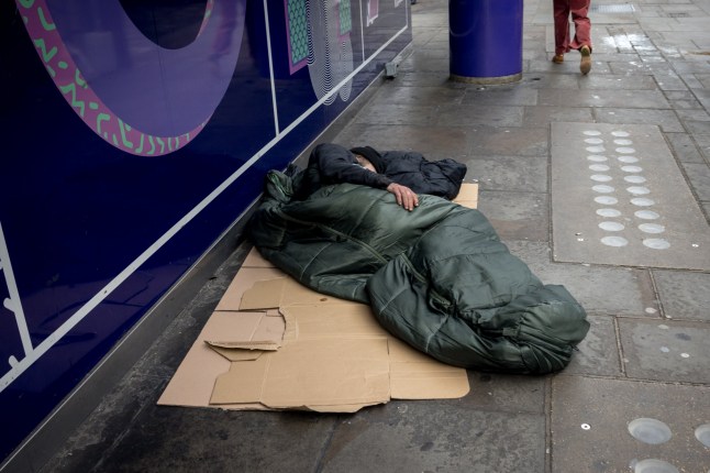LONDON, ENGLAND - OCTOBER 24: A homeless person lies in a sleeping bag on a pavement on October 24, 2024 in London, England. Data released earlier this year revealed that the number of people rough sleeping in London between January to March 2024 rose by 33 percent to 4118 year on year. (Photo by Jack Taylor/Getty Images)