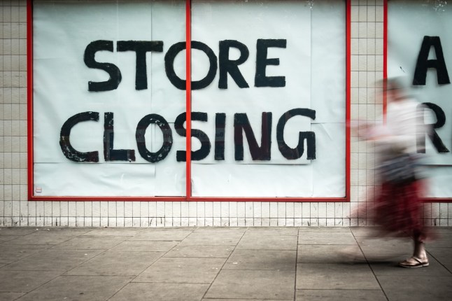 High Street 'Store Closing' sign with motion blurred shopper walking past; Shutterstock ID 1451250893; purchase_order: -; job: -; client: -; other: -