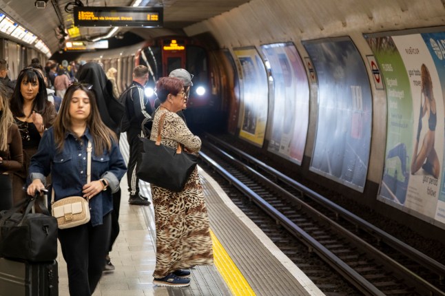 Passengers on the Tube waiting for an approaching train.