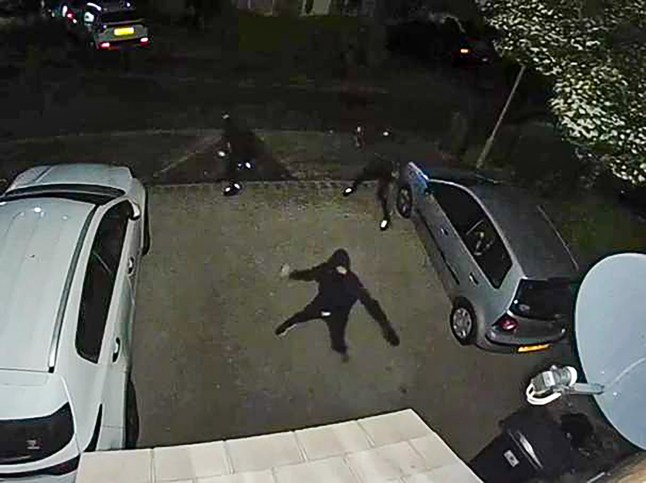 Pictured: CCTV footage of the attack on a property on Allbrook Knoll, Eastleigh. Two care workers have been left 'terrified' after their family home was attacked by three hooded men who threw rocks into their children's bedroom. Their six year old daughter even asked 'Mummy, why would anyone want to hurt my windows?' following the late night assault which also saw eight tyres slashed. The mother, who only gave her name as Erica for fear of further attacks, and her unnamed husband heard the noise and thought there was an intruder in their home but when they went to investigate they only found smashed windows. They then rushed to check on their son and daughter's room where the pair found a smashed window and three rocks on their daughter's bed, Erica cut her foot on some glass in her rush to check on the children. SEE OUR COPY FOR DETAILS. Please byline: Daily Echo/Solent News ?? Daily Echo/Solent News & Photo Agency UK +44 (0) 2380 458800