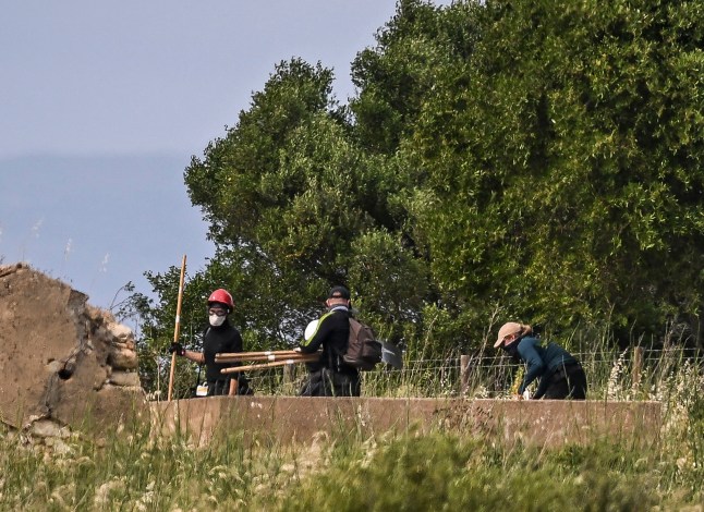 Investigators work during a new search operations amid the investigation into the disappearance of Madeleine (or Maddie) McCann at Atalaia, Lagos in Algarve on June 3, 2025. Portuguese police and about 25 German investigators on June 3, 2025 scoured undergrowth and an abandoned building in Portugal in the hunt for British toddler Madeleine McCann, with police hoping to find evidence that could implicate a convicted German sex offender in her disappearance 18 years ago. (Photo by Patricia DE MELO MOREIRA / AFP) (Photo by PATRICIA DE MELO MOREIRA/AFP via Getty Images)