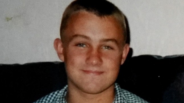 Michael Ross photo used in The Orkney Assassin documentary. He is wearing a checkered shirt and smiling.