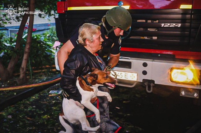 epa12161559 A handout photo released by the press service of the State Emergency Service (SES) of Ukraine shows a woman carrying a dog being assisted by an officer near the site of an airstrike in Kharkiv, northeastern Ukraine, 07 June 2025, amid the Russian invasion. At least three people were killed and 21 others injured, including two children, after Russian forces launched an overnight attack on Kharkiv and its suburbs, Kharkiv Mayor Ihor Terekhov wrote on telegram. EPA/STATE EMERGENCY SERVICE OF UKRAINE HANDOUT -- BEST QUALITY AVAILABLE -- MANDATORY CREDIT: STATE EMERGENCY SERVICE OF UKRAINE -- HANDOUT EDITORIAL USE ONLY/NO SALES