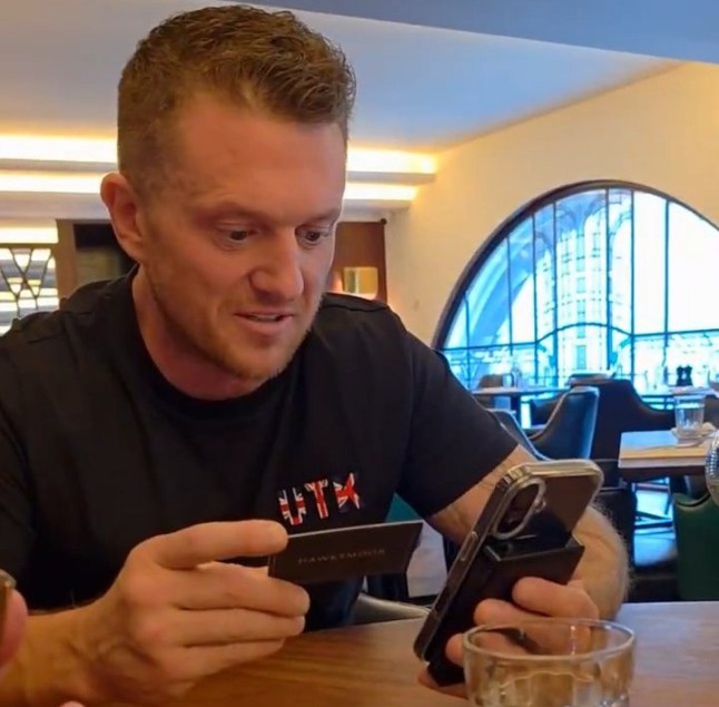 Tommy Robinson on his phone.