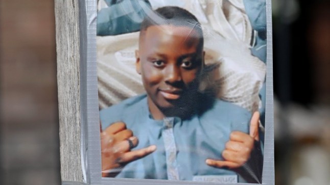 A photo is taped to a barrier at the scene in Manchester where a 14 year old was stabbed to death, June 9 2025. Two teenagers have been arrested on suspicion of murder after a 14-year-old boy was stabbed, police have said. Police, paramedics and an air ambulance were called to Nevin Road in the New Moston area of Manchester at about 17:00 BST on Sunday. The boy, who was found with stab wounds, later died in hospital, added Greater Manchester Police (GMP).