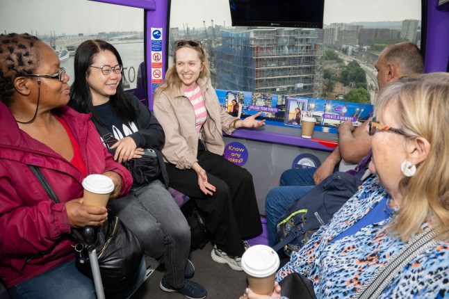 People chatting and laughing inside the IFS Cloud Cable Car in London.