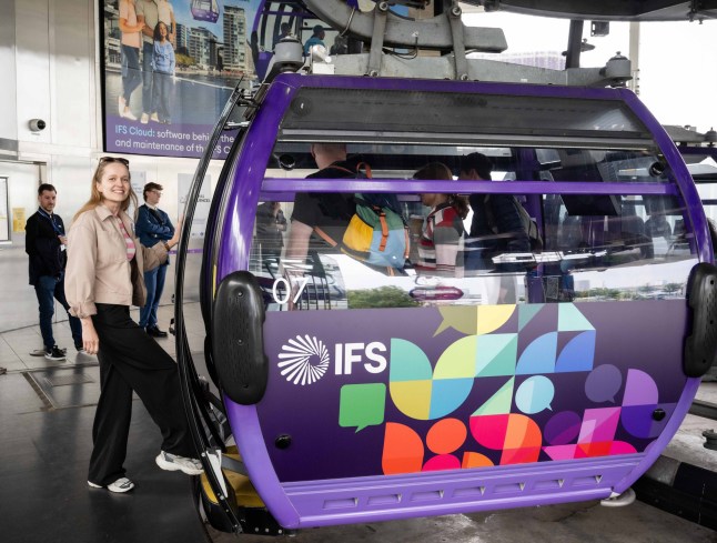 A person stepping into the London IFS Cloud Cable Car chatty cabin.
