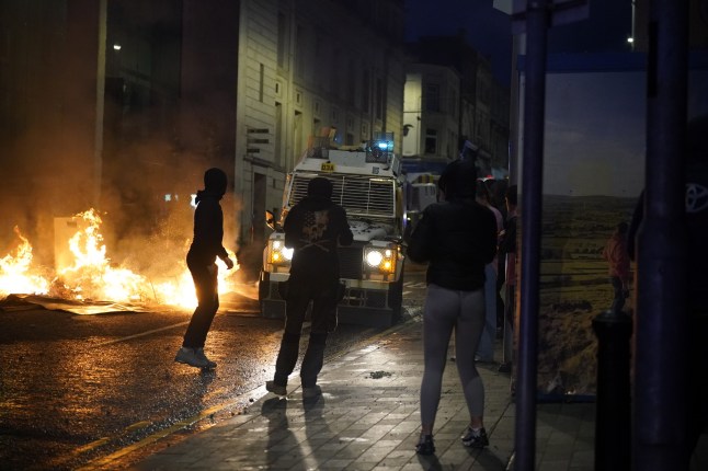 People take part in a protest over an alleged sexual assault in the Co Antrim town of Ballymena. Police used water cannon to disperse protesters engaged in serious disorder for a second night in Ballymena, as fireworks and masonry were thrown at officers. Picture date: Tuesday June 10, 2025. PA Photo. See PA story ULSTER Ballymena. Photo credit should read: Niall Carson/PA Wire