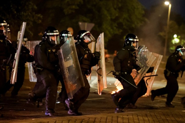 Police officers take position during a second night of riots, in Ballymena, Northern Ireland, June 10, 2025. REUTERS/Clodagh Kilcoyne