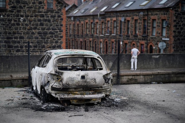 A burnt-out car on the street following a second night of violence in Ballymena, during a protest over an alleged sexual assault in the Co Antrim town. Multiple cars and properties were set on fire in Ballymena while rioters hurled petrol bombs, fireworks and masonry at police officers. Picture date: Wednesday June 11, 2025. PA Photo. Photo credit should read: Niall Carson/PA Wire