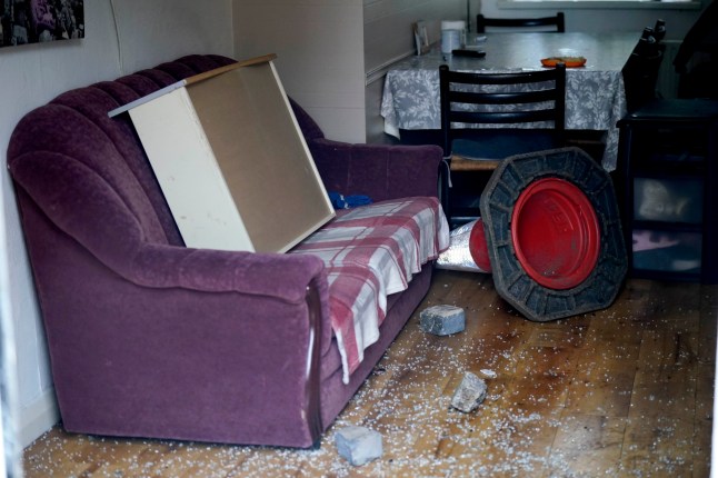 A traffic cone and bricks alongside broken glass inside a property that was ransacked in a second night of violence in Ballymena, during a protest over an alleged sexual assault in the Co Antrim town. Multiple cars and properties were set on fire in Ballymena while rioters hurled petrol bombs, fireworks and masonry at police officers. Picture date: Wednesday June 11, 2025. PA Photo. Photo credit should read: Niall Carson/PA Wire