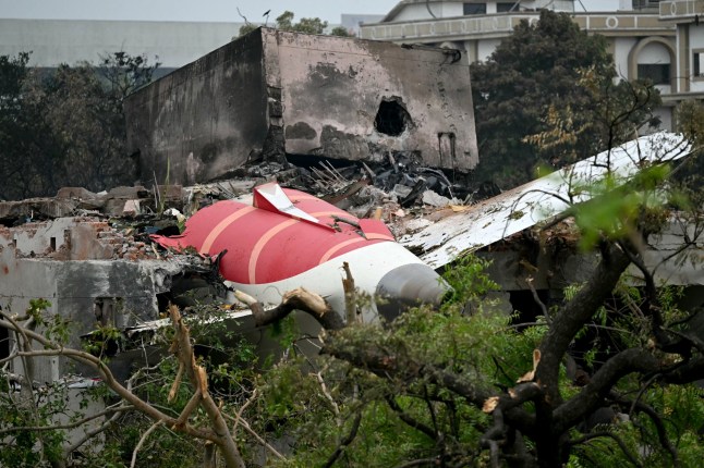 TOPSHOT - Debris of Air India flight 171 is pictured after it crashed in a residential area near the airport in Ahmedabad on June 13, 2025. Rescue teams with sniffer dogs combed the crash site on June 13 of a London-bound passenger jet which ploughed into a residential area of India's Ahmedabad city, killing at least 265 people on board and on the ground. (Photo by Punit PARANJPE / AFP) (Photo by PUNIT PARANJPE/AFP via Getty Images)