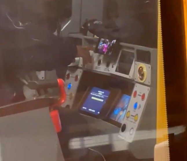 Moment Tube driver is caught KNITTING and watching videos on his phone while driving commuters Credit SWNS