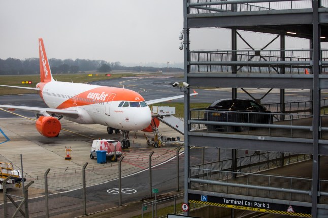 A passenger aircraft, operated by Easyjet Plc, next to a passenger car park on the tarmac at London Luton Airport in Luton, U.K., on Friday, Jan. 8, 2021. Airlines kicked off 2021 by shrinking their already meager U.K. schedules, prompted by a new coronavirus lockdown and the prospect of further restrictions on travel abroad. Photographer: Chris Ratcliffe/Bloomberg via Getty Images