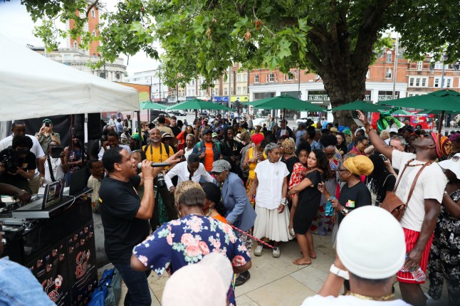 LONDON, ENGLAND - JUNE 23: People dance and gather in Windrush Square, Brixton to celebrate the 76th anniversary of Windrush on June 23, 2024 in London, England. Windrush Day in the UK celebrates the Caribbean communities' contributions to the UK since the citizens began arriving on British Shores on the HMT Empire Windrush in 1948. (Photo by Alishia Abodunde/Getty Images)