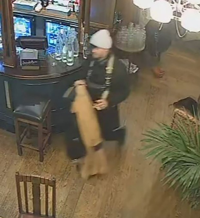 CCTV footage still of a suspect in the theft of the violin, pictured walking through the pub.