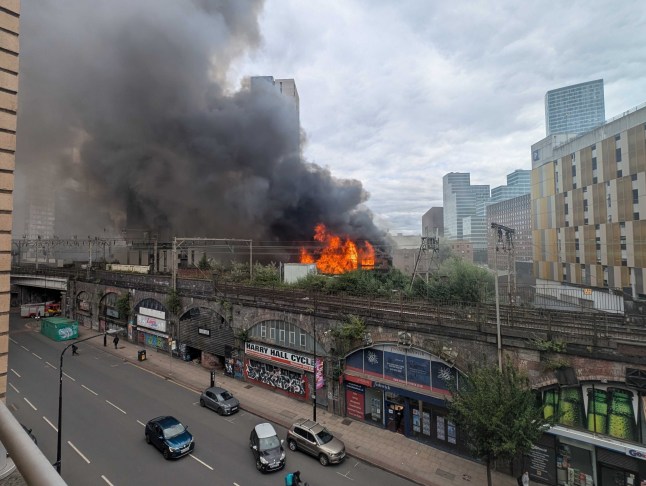 Plumes of smoke seen for MILES as fire ravages historic Manchester Hotspur Press building