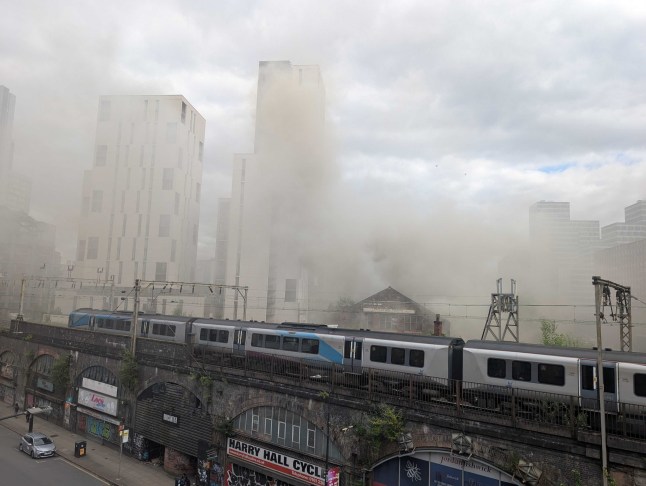 Plumes of smoke seen for MILES as fire ravages historic Manchester Hotspur Press building