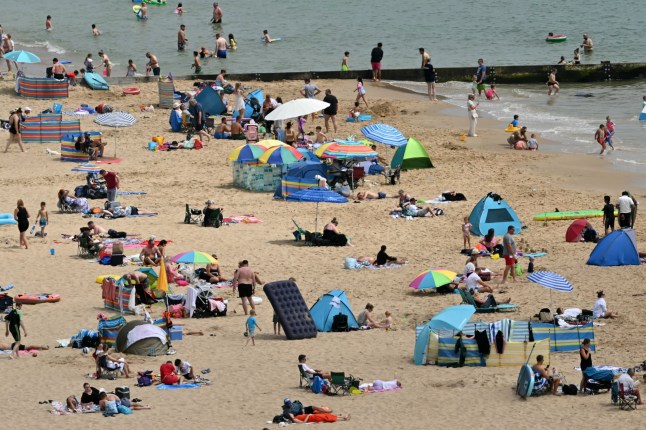 Sunbathers cover the beaches in Bournemouth on the south coast of England on June 29, 2025. Temperatures in parts of England are expected to soar again Sunday after a second amber heat health alert in two weeks came into force on Friday. (Photo by JUSTIN TALLIS / AFP) (Photo by JUSTIN TALLIS/AFP via Getty Images)