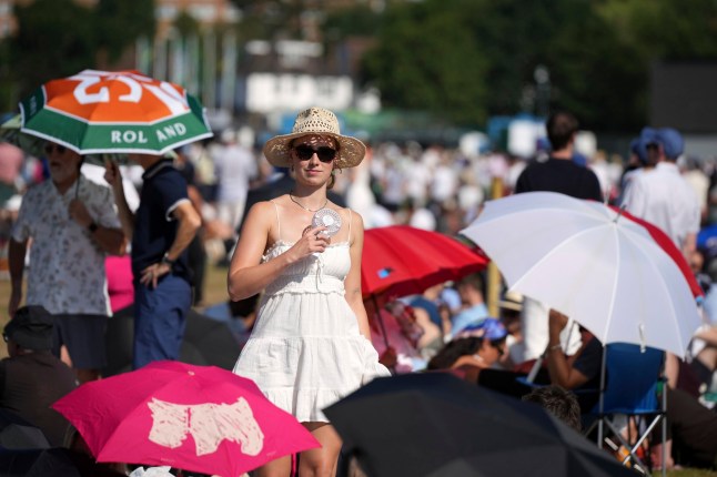 People queue at the entrance on the first day of the Wimbledon Tennis Championships in London, Monday, June 30, 2025. (AP Photo/Alastair Grant)