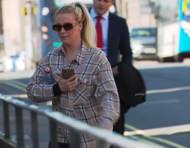 Sophie-Leigh Gemmell is pictured walking into court wearing a grey shirt and sunglasses