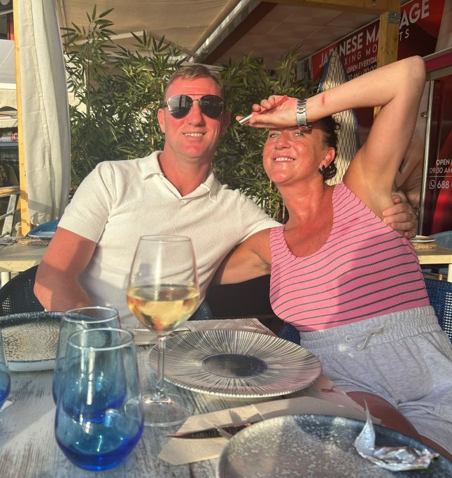 PIC FROM Kennedy News and Media (PICTURED: 42-YEAR-OLD EMMA HICKEY AND 44-YEAR-OLD STEPHEN BROUGHAM IN TENERIFE) A mum is fighting for her life after plummeting down hotel stairs and hitting her head - as an infection from MOSQUITO BITES made her faint. Emma Hickey and her partner Stephen Brougham took their two kids to Costa Adeje, Tenerife, Spain, on June 13th for a sun-soaked 12-day getaway. Just 11 days into the trip, the mum-of-two woke up with a 'really bad case' of mosquito bites so went to hospital and was prescribed injections. DISCLAIMER: While Kennedy News and Media uses its best endeavours to establish the copyright and authenticity of all pictures supplied, it accepts no liability for any damage, loss or legal action caused by the use of images supplied and the publication of images is solely at your discretion. SEE KENNEDY NEWS COPY - 0161 697 4266