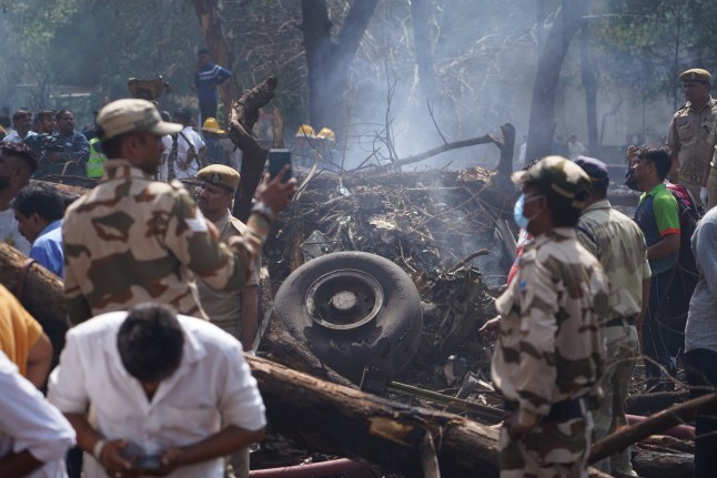 epa12171327 Officials inspect debris at the site of a plane crash near Sardar Vallabhbhai Patel International Airport in Ahmedabad, Gujarat, western India, 12 June 2025. Air India flight AI171, bound for London carrying 242 passengers and crew members on board a Boeing 787-8 aircraft, crashed minutes after take-off in the Meghaninagar area of Ahmedabad. EPA/SIDDHARAJ SOLANKI